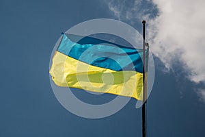 National Flag of Ukraine against the blue sky.