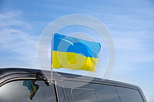 National flag of Ukraine on car window outdoors