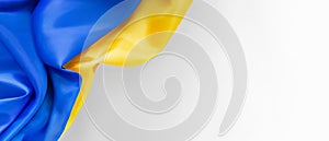 National flag of Ukraine. Fabric curved in yellow-blue colours ribbons on white background. National symbol of country. Europe.