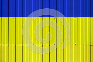 National flag of Ukraine on fence.