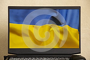 The national flag of Ukraine is yellow-blue as a background on a laptop, peace in Ukraine, no war, free country Ukraine