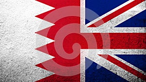 National flag of United Kingdom Great Britain Union Jack with The Kingdom of Bahrain national flag. Grunge background