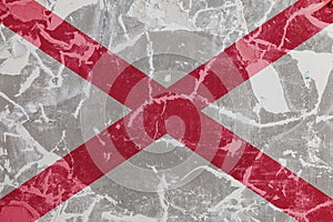 The national flag of the US state Alabama against a gray wall with cracks and faults on the day of independence in colors of red