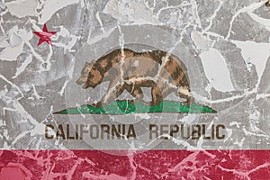 The national flag of the US state California in against a gray wall with cracks and faults on the day of independence in red and