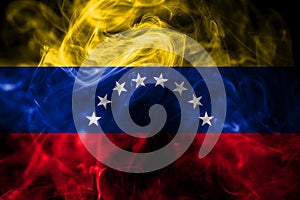 National flag of Venezuela made from colored smoke isolated on black background. Abstract silky wave background.