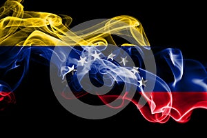 National flag of Venezuela made from colored smoke isolated on black background. Abstract silky wave background