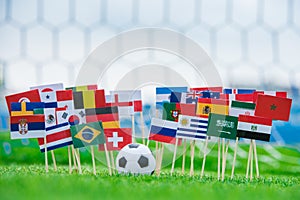 National Flags of all football countries on green grass, Football ball on the stadium