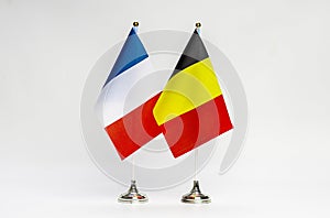 National flags of France and Belgium on a light background.