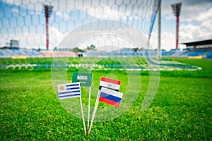 National Flags of Russia, Saudi Arabia, Egypt, Uruguay. Flags on green grass on football stadium