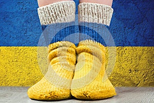 National flags of Ukraine on a pair wool knitted socks. Symbolizing a fighting against war