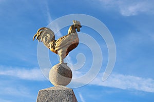 National French Emblem, the Gallic Rooster, against a Bright Blue Sky.