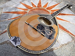 The national Greek stringed plucked musical instrument Bouzouki lies on a marble table in Greece photo