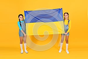 National identity concept. Ukrainian kids. Girls with blue and yellow flag. Patriotic education. Happy independence day