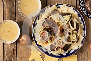 National Kazakh dish - Beshbarmak and bouillon in the bowls