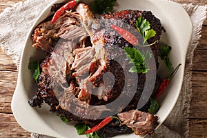 National Latin American dish of Pernil Asado shredded pork closeup on a plate. horizontal top view