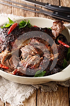 National Latin American dish of Pernil Asado shredded pork closeup on a plate. vertical photo