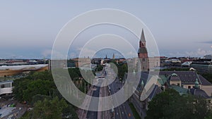 National museum historic building contracting with modern urban borough nearby. Cityscape at dusk. Helsinki, Finland