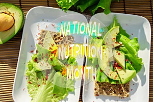 National Nutrition Month features a nutritious salad on a slice of rye bread and avocado, healthy eating habits.