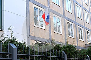 National red, blue, white flag of state of Russian Federation on silk on facade of building of Consulate General of Russia,