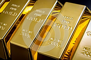 National reserve of gold, financial stability and commodity trading concept with many pure solid gold bars in a raw on black