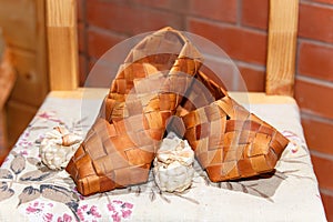National Russian bast shoes on brick background