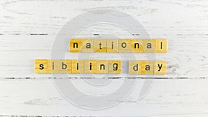National Siblings Day.words from wooden cubes with letters