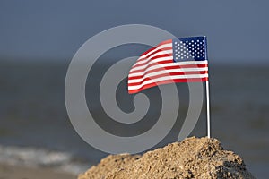 National table flag of USA on sea background. Holiday in America on sea