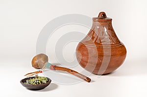 Native American Clay Pot with Rawhide Shaker and Dish of Healing Herbs. photo