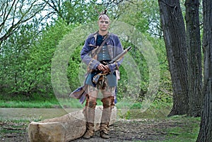 Native American with dugout canoe with rifle