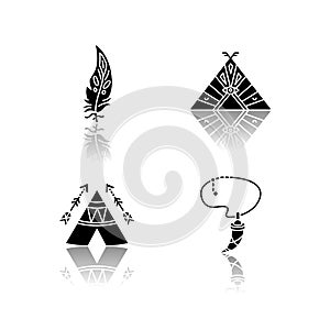Native american indian accessories drop shadow black glyph icons set. Necklace with tooth, eagle feather. Wigwam with