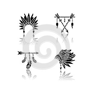 Native american indian hat and amulet drop shadow black glyph icons set. Tribe chief headdress with feathers. Boho style