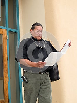 Native American man glancing at papers