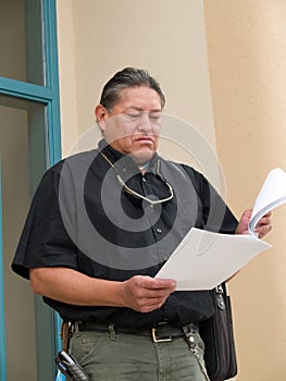 Native American man glancing at papers