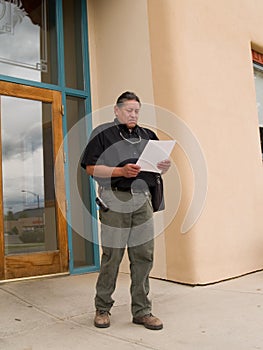 Native American man glancing at papers