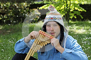 Native American man playing a wooden flute