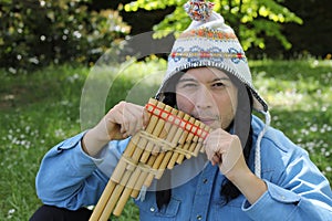 Native American man playing a wooden flute