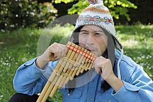 Native American man playing a wooden flute