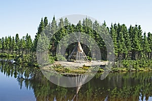 Native American tipi on a lakeshore