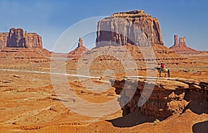 A native American walks his horse in Monument Valley.