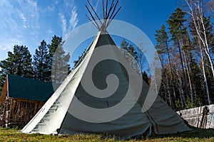 Native American wigwam in the forest. Modern material for the manufacture of wigwam. Yurt is the home of the northern peoples photo