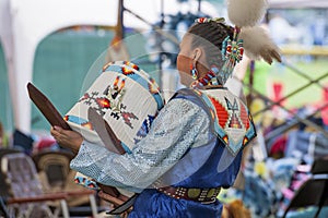 Native American woman dances with Papoose Cradleboard