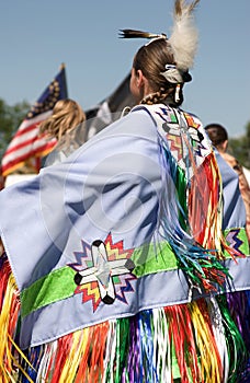 Native American woman displaying her costume at Minneapolis POW WOW