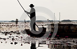 The native fisherman started working early in the boat in the morning in Thailand