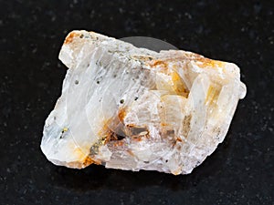 native gold in raw quartz stone on dark