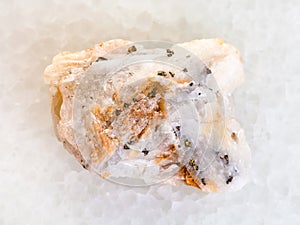 native gold in raw quartz stone on white marble