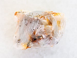 native gold in rough quartz stone on white marble