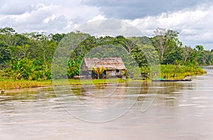 Native house along a rain forest river