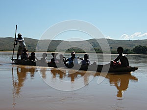 Native Malagasy people crossing river