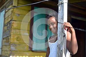 Native Nicaraguan girl smiling clapboard house Big Corn Island photo
