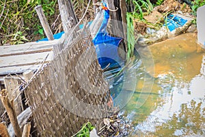 Native Thai fish trap made from weaved bamboo with blue nylon ne